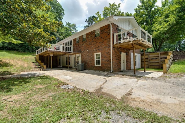 260 Sequoia Rd NW, Cleveland, TN 37312 - rear view of house featuring a deck, a patio, brick siding, concrete driveway, and a yard