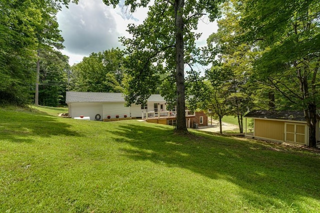 260 Sequoia Rd NW, Cleveland, TN 37312 - view of green lawn featuring a wooden deck, a shed, and a garage
