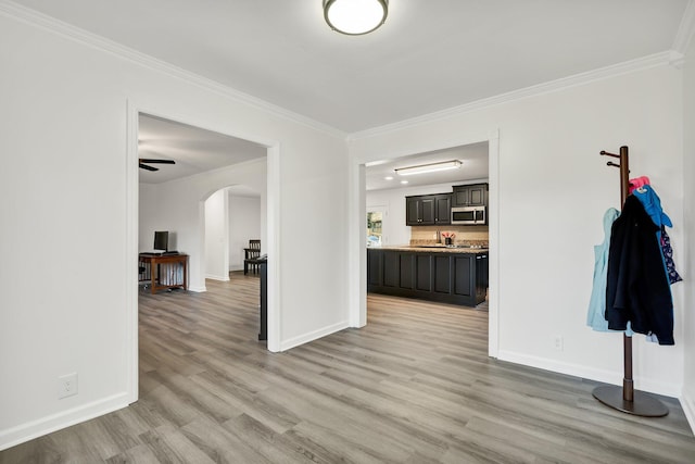 interior space with ornamental molding and light wood-type flooring