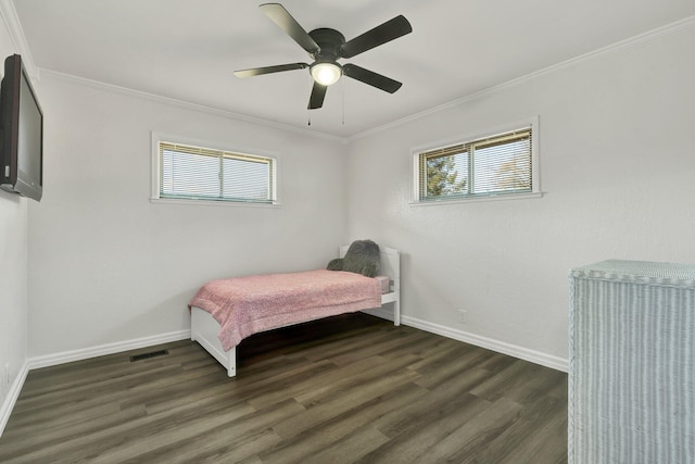 bedroom with ornamental molding, dark hardwood / wood-style flooring, and multiple windows