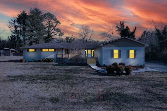 ranch-style home with a yard