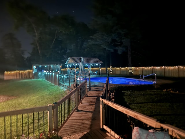 dock area featuring a fenced in pool and a yard