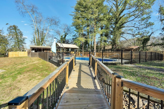 exterior space featuring a fenced in pool and a lawn