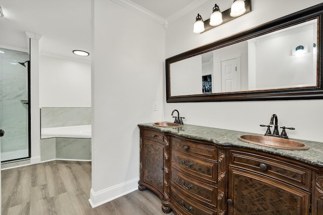 bathroom with crown molding, wood-type flooring, plus walk in shower, and vanity