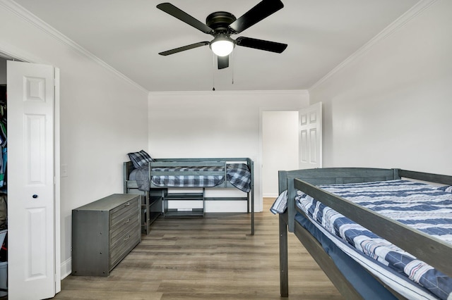 bedroom featuring crown molding, hardwood / wood-style floors, and ceiling fan