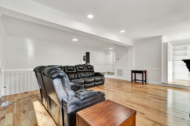 living room with crown molding and light hardwood / wood-style floors