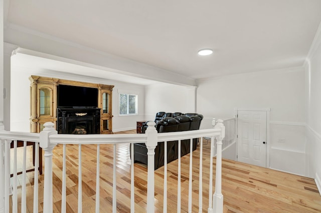 living room featuring hardwood / wood-style floors and crown molding