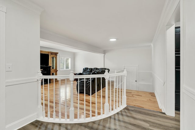 hall featuring hardwood / wood-style flooring and crown molding