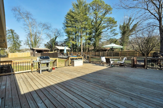 wooden deck featuring area for grilling and a yard