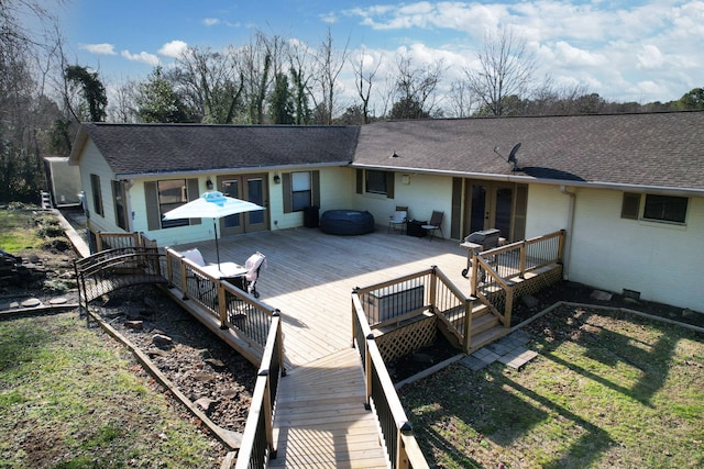 rear view of property featuring a deck