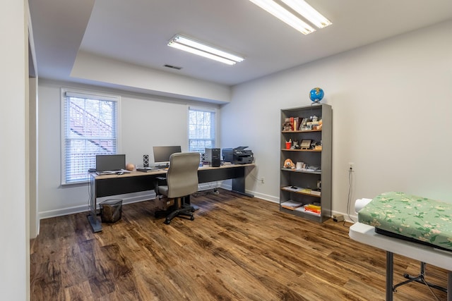 home office featuring visible vents, baseboards, and wood finished floors