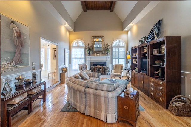 living room featuring a wealth of natural light, light wood-style flooring, and high vaulted ceiling
