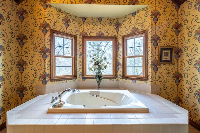 bathroom with wallpapered walls and a garden tub