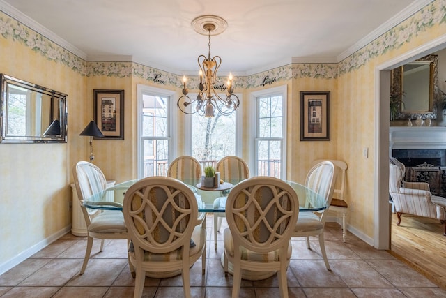 dining area with baseboards, plenty of natural light, a chandelier, and wallpapered walls