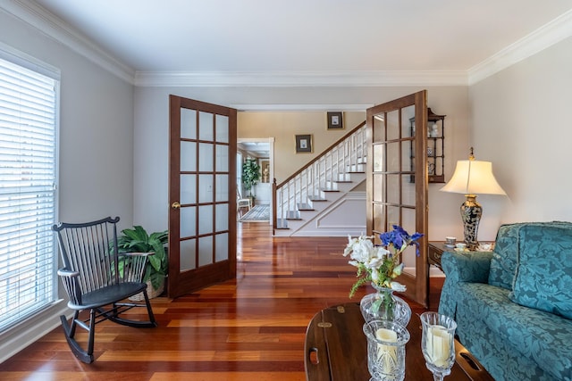 interior space featuring a wealth of natural light, wood finished floors, stairs, and ornamental molding