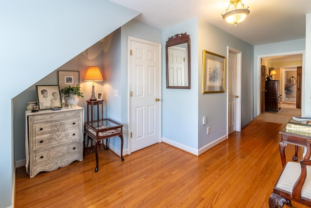 interior space with baseboards and light wood finished floors