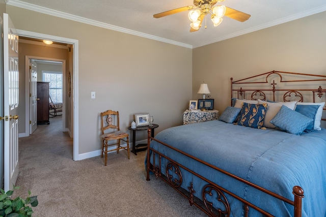 carpeted bedroom with baseboards, ornamental molding, and a ceiling fan