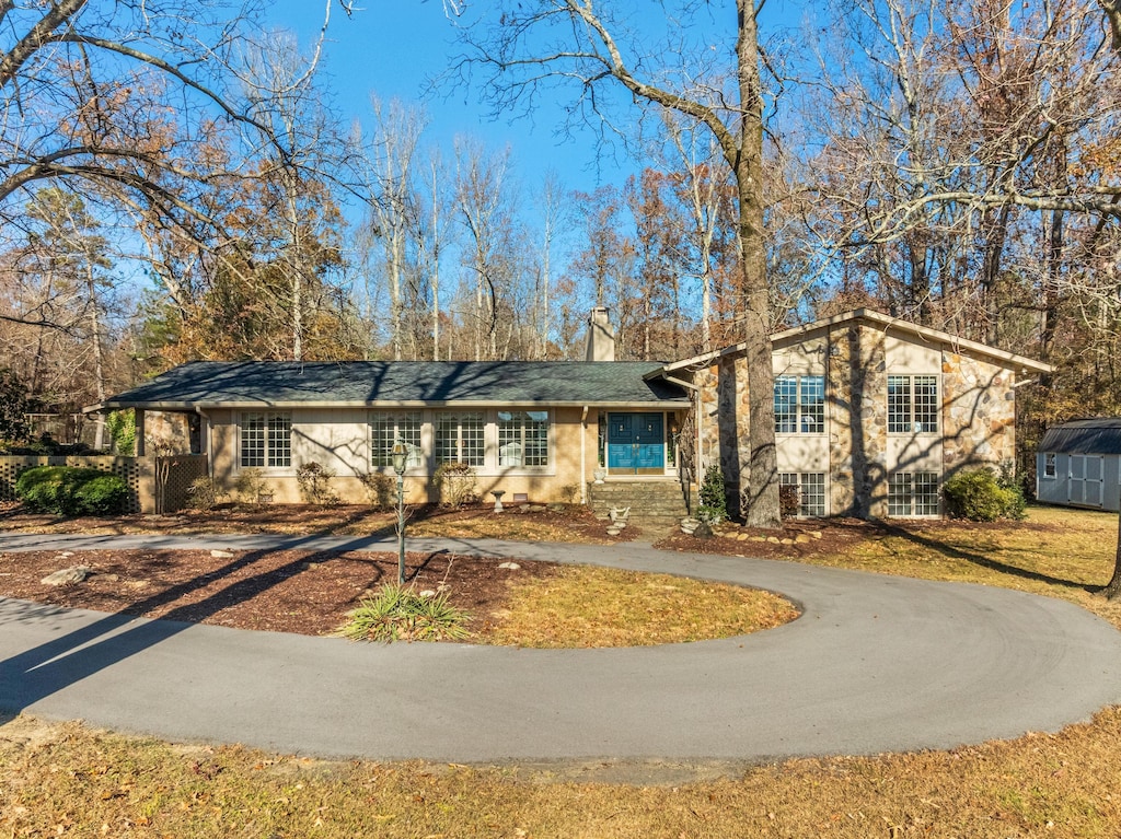 view of front of home with a storage shed