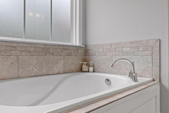 bathroom featuring tiled tub