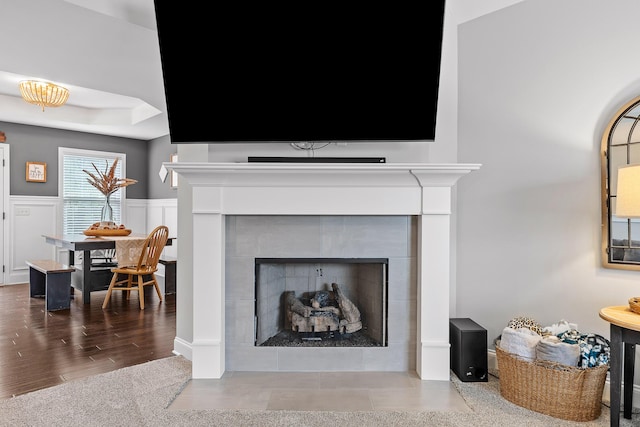 interior details featuring a tiled fireplace and hardwood / wood-style floors