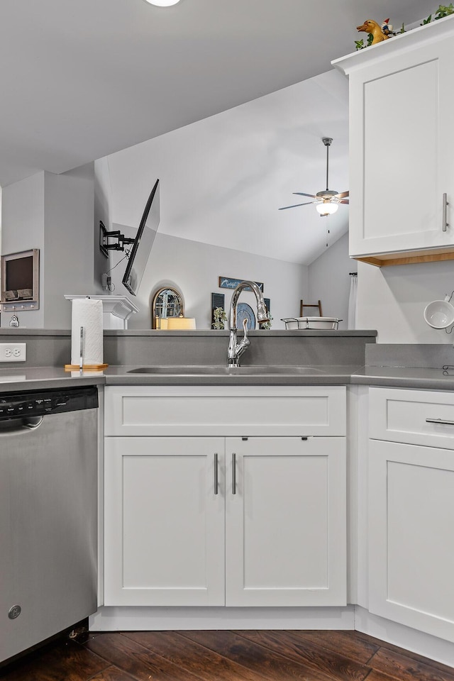 kitchen with ceiling fan, dishwasher, sink, vaulted ceiling, and white cabinets