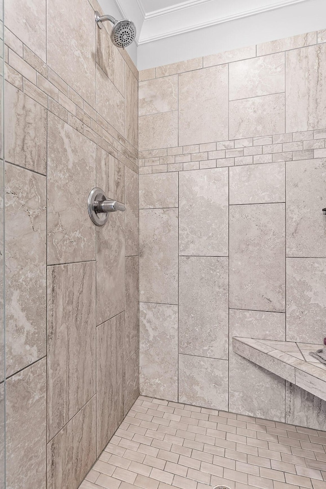 room details with a tile shower and crown molding