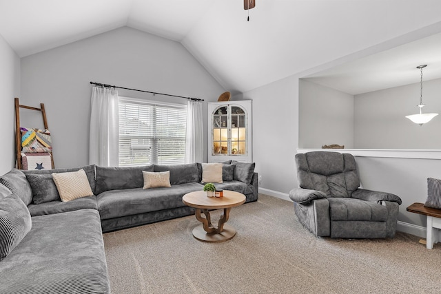 living room featuring carpet, ceiling fan, and vaulted ceiling