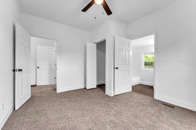 unfurnished bedroom with ceiling fan and carpet floors