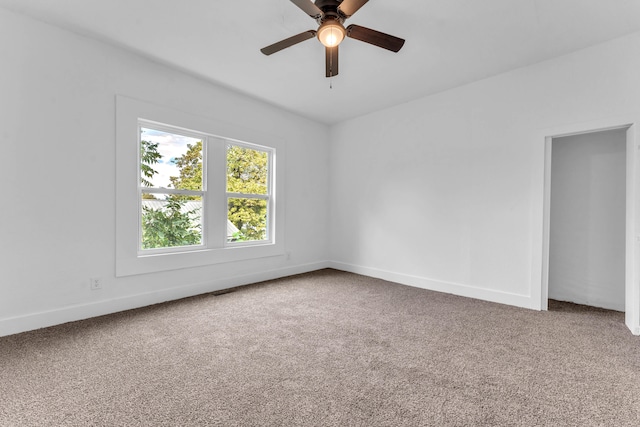 empty room with carpet and ceiling fan