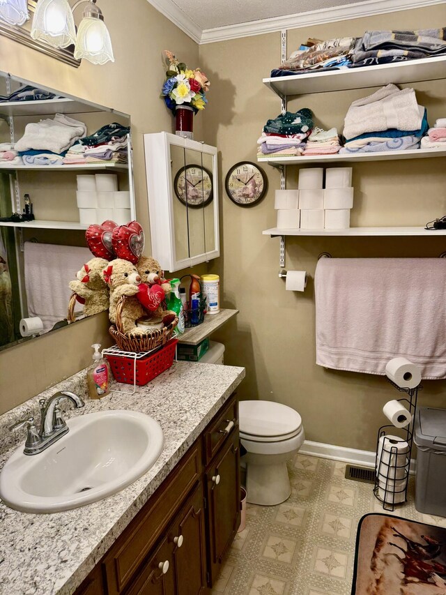 2510 Burning Tree Dr NW, Cleveland, TN 37312 - bathroom featuring vanity, toilet, visible vents, baseboards, and ornamental molding