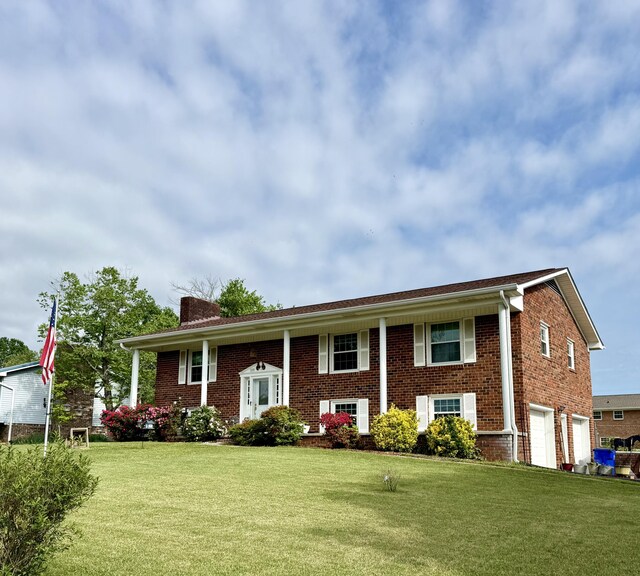 2510 Burning Tree Dr NW, Cleveland, TN 37312 - bi-level home with a chimney, a front yard, brick siding, and a garage