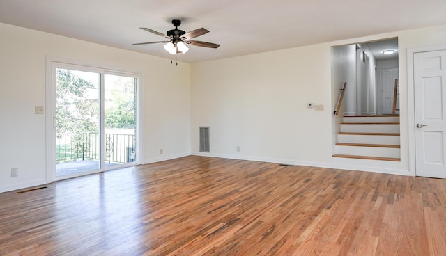 spare room featuring wood-type flooring and ceiling fan