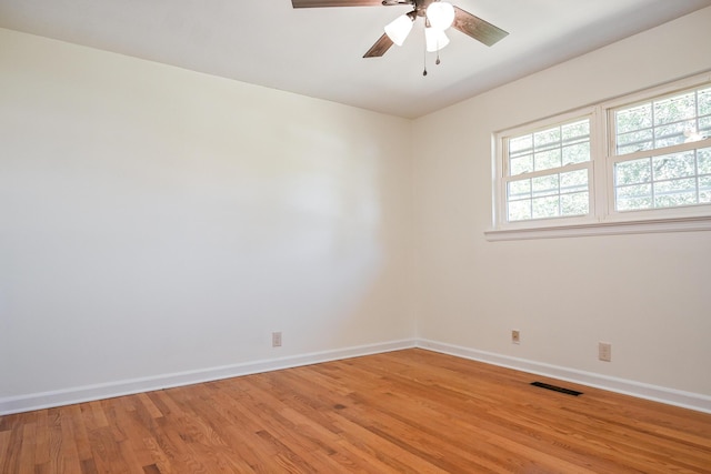 empty room with light hardwood / wood-style floors and ceiling fan