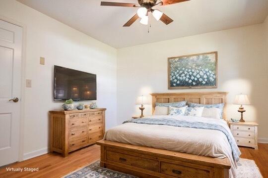 bedroom featuring hardwood / wood-style floors and ceiling fan