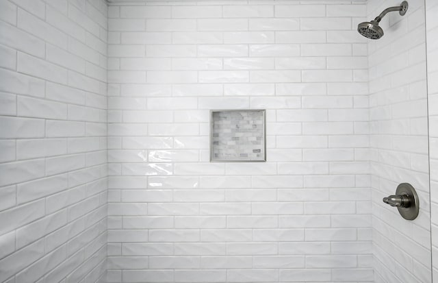 bathroom with a tile shower