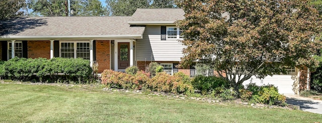 view of front of property with a front yard and a garage