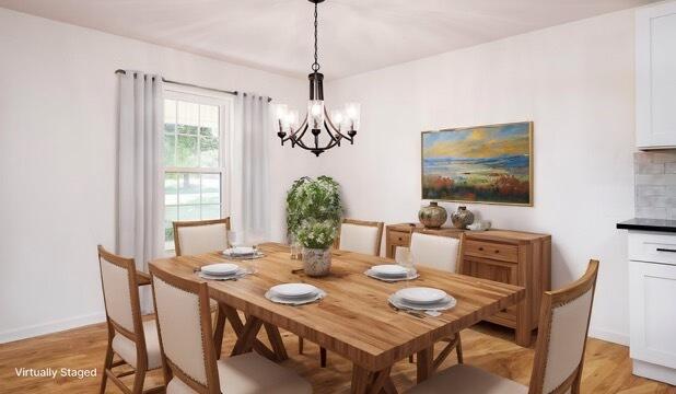 dining room featuring an inviting chandelier and light wood-type flooring