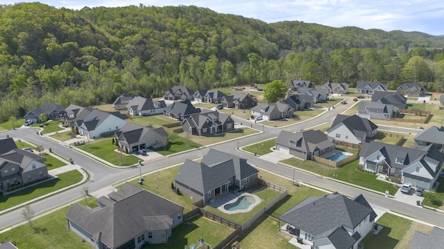 birds eye view of property with a residential view and a wooded view