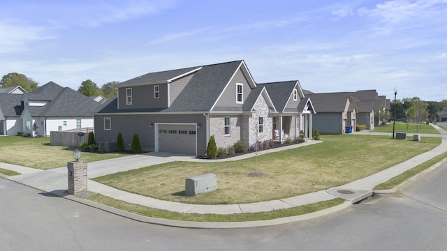 view of front of home featuring a front lawn, driveway, a residential view, and roof with shingles