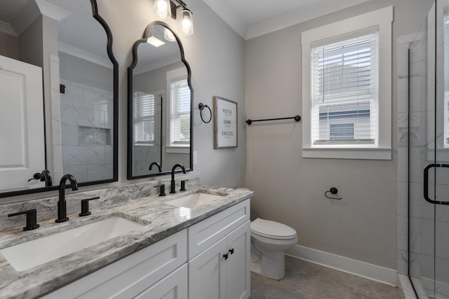 bathroom with baseboards, crown molding, a stall shower, and a sink