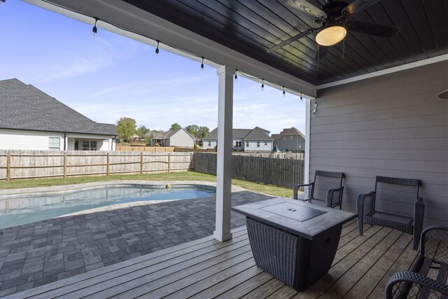 wooden terrace with a fenced backyard, a residential view, and a ceiling fan