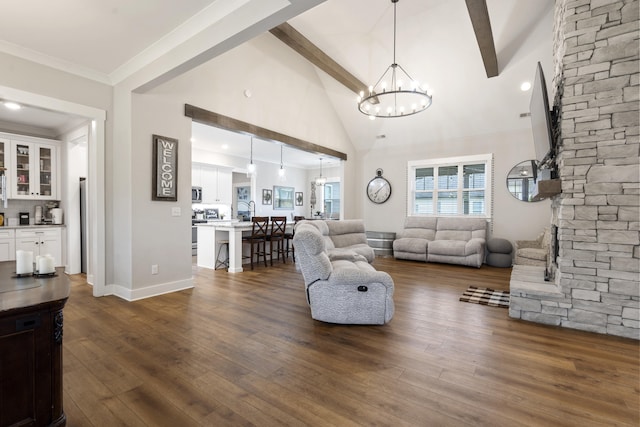 living area with dark wood finished floors, baseboards, an inviting chandelier, beamed ceiling, and high vaulted ceiling