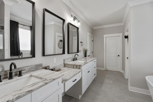 full bathroom with a freestanding bath, visible vents, baseboards, crown molding, and vanity