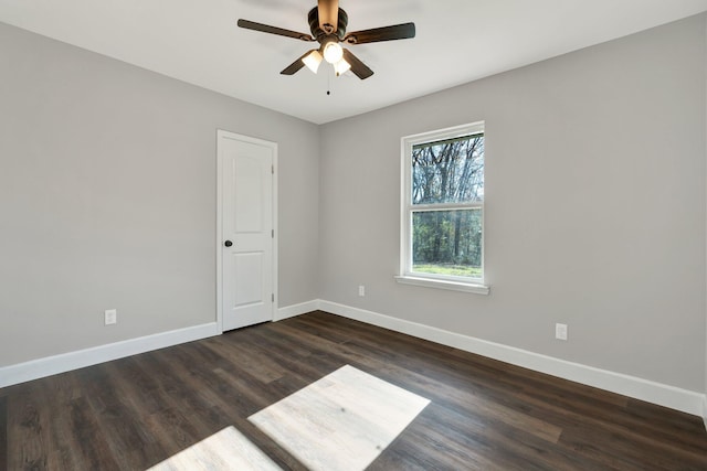 empty room featuring ceiling fan and dark hardwood / wood-style floors