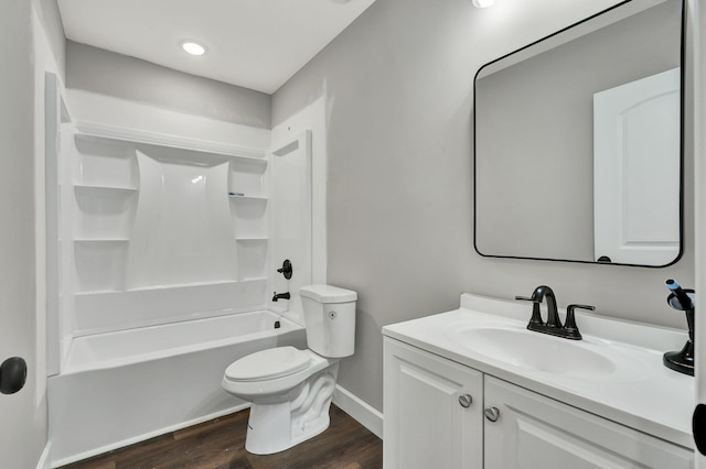 full bathroom featuring hardwood / wood-style floors, vanity, bathing tub / shower combination, and toilet