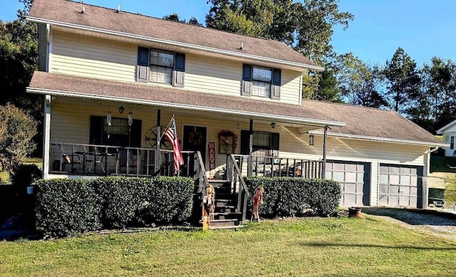 view of front of house featuring a garage, a front lawn, and a porch