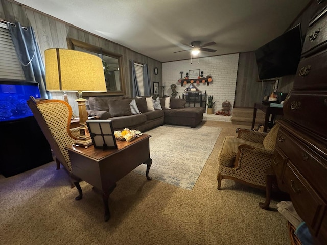 living room with ceiling fan, brick wall, wood walls, and carpet