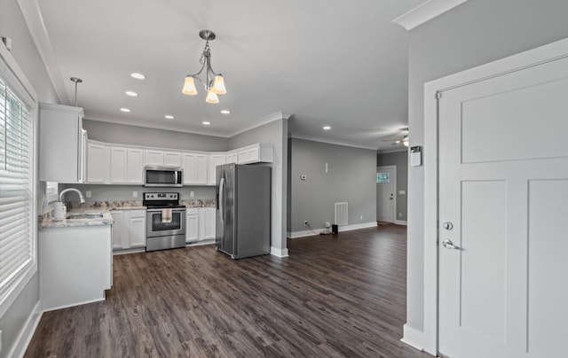 264 Courtland Crest Dr SW, Cleveland, TN 37311 - kitchen with appliances with stainless steel finishes, open floor plan, crown molding, white cabinetry, and dark wood-style floors