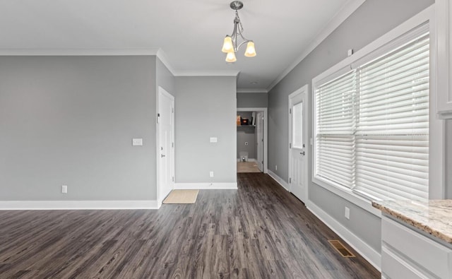 264 Courtland Crest Dr SW, Cleveland, TN 37311 - empty room with crown molding, dark wood finished floors, and a chandelier