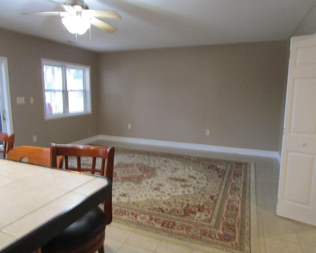 tiled dining room featuring ceiling fan